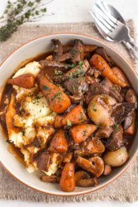 MUSHROOM ROOT VEGETABLE BOURGUIGNON WITH MASHED POTATOES